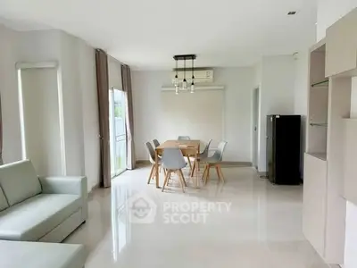 Spacious modern living room with dining area and sleek furniture