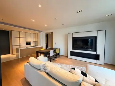 Modern open-layout living room with sleek kitchen and cozy seating area