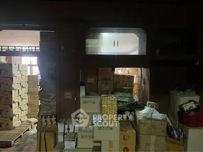 Spacious storage room filled with boxes and supplies, ideal for business inventory management.
