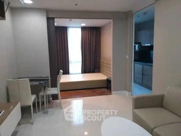Modern apartment interior with open living area and cozy bedroom nook.