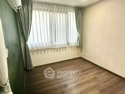 Spacious empty room with large window and elegant curtains, perfect for customization.