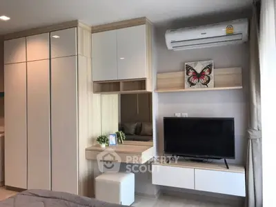 Modern bedroom with built-in wardrobe and wall-mounted TV
