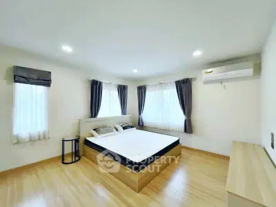 Spacious bedroom with modern decor and natural light