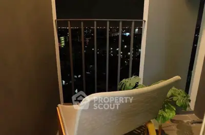 Cozy balcony with night city view, perfect for relaxation.