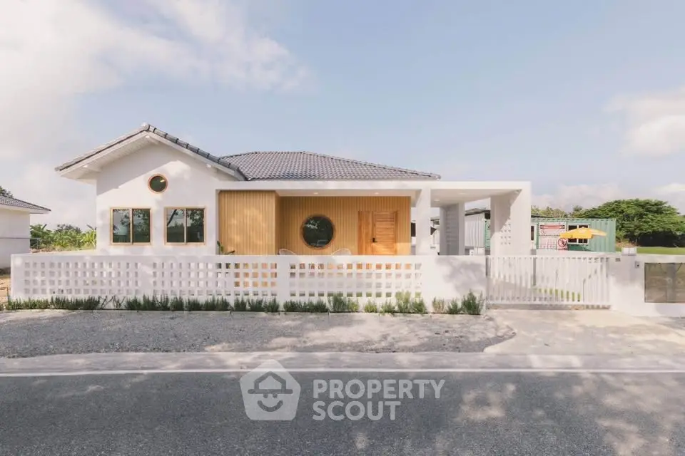 Charming modern house with unique circular windows and stylish facade, perfect for contemporary living.