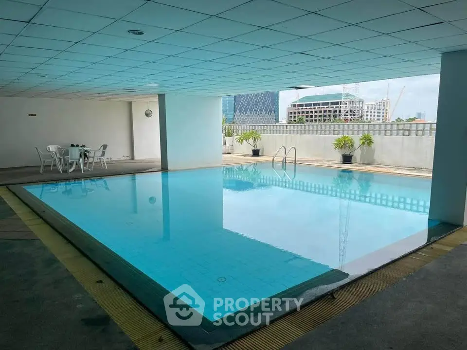 Luxurious indoor pool with city view, perfect for relaxation and leisure in modern real estate.
