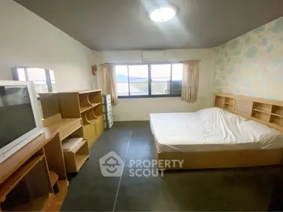 Cozy bedroom with scenic window view and modern furnishings