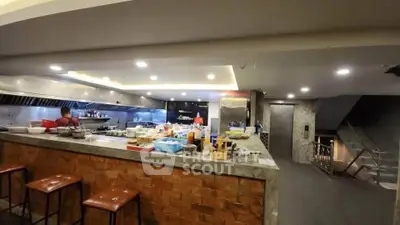 Spacious modern kitchen with open layout and brick island, ideal for culinary enthusiasts.