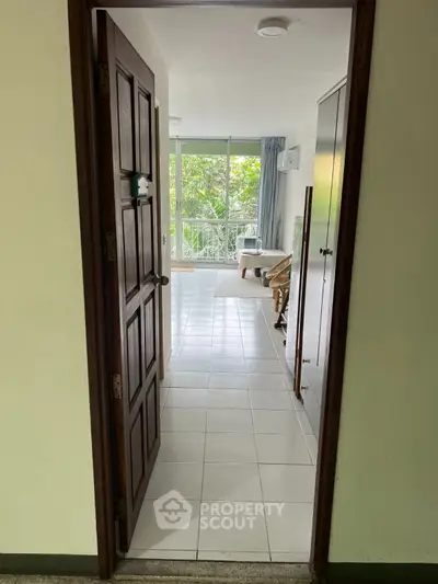 Inviting entrance to a bright living space with balcony view and natural light.