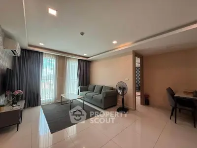 Spacious modern living room with sleek furniture and large windows.