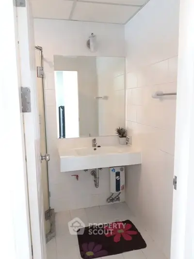 Modern bathroom with sleek white tiles and minimalist sink design