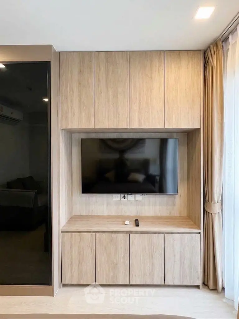 Modern living room with built-in wooden TV cabinet and sleek design