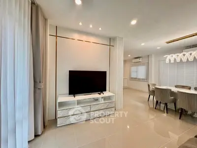 Modern living room with sleek TV stand and elegant dining area