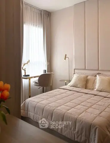 Elegant bedroom with modern decor and natural light, featuring a cozy bed and stylish furnishings.