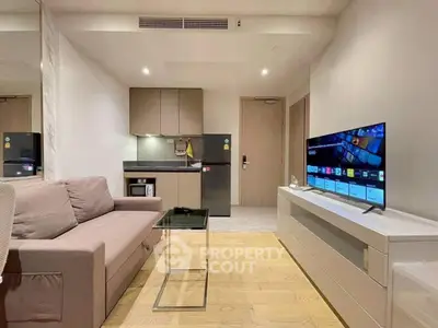 Modern living room with sleek furniture and smart TV in a stylish apartment.