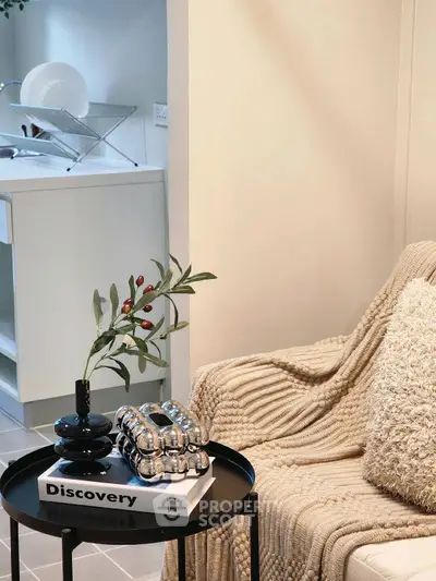 Cozy living room with modern decor and kitchen view