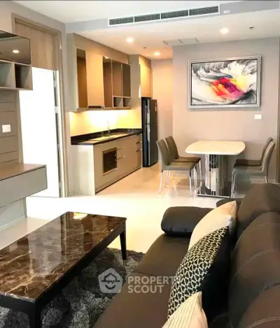 Modern open-layout living room and kitchen with stylish decor and contemporary furniture.
