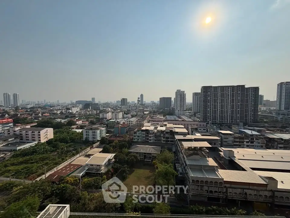Stunning cityscape view from high-rise building showcasing urban skyline and lush greenery.