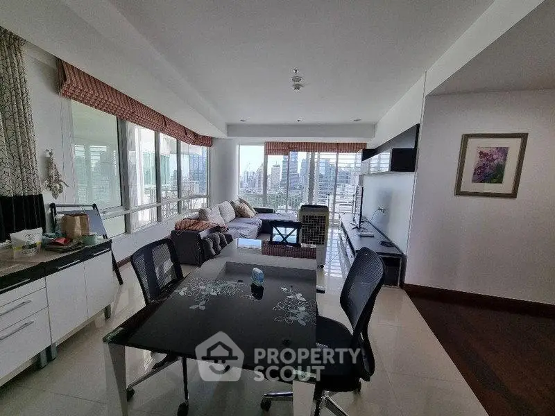 Spacious living room with city view and modern furnishings