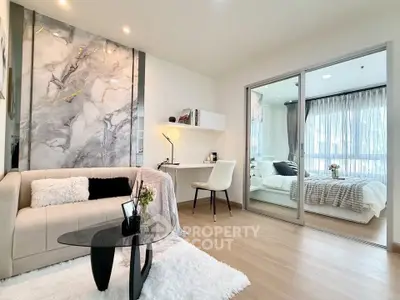 Modern living room with elegant marble accent wall and cozy workspace