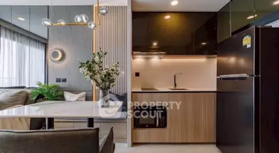 Modern open-layout kitchen and living room with stylish decor and natural light.