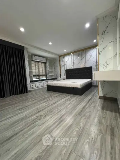 Luxurious bedroom with elegant marble walls and modern furnishings