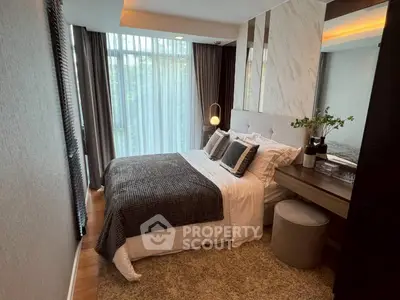 Luxurious bedroom with elegant decor and large window offering natural light