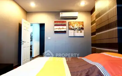 Modern bedroom with stylish decor and air conditioning in a cozy apartment.