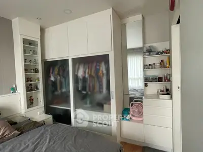 Modern bedroom with sleek wardrobe and organized storage solutions