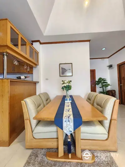 Elegant dining area with wooden furniture and modern decor in a cozy apartment