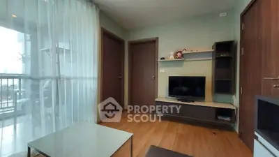 Modern living room with balcony access and sleek wooden flooring