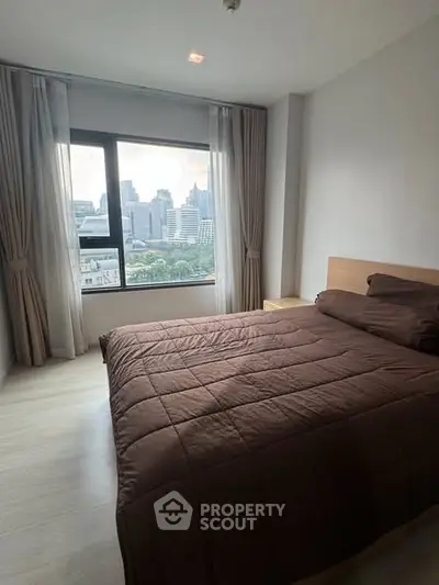 Spacious bedroom with city view in modern apartment