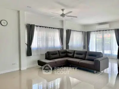 Spacious modern living room with corner sofa and large windows