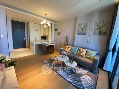 Modern living room with stylish decor and open kitchen layout in a luxury apartment.