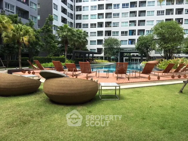 Luxurious condominium with poolside lounge area and lush greenery, perfect for relaxation and leisure.