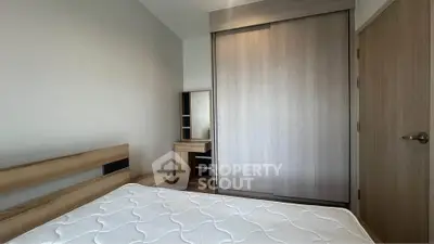 Modern bedroom with wooden furniture and built-in wardrobe, perfect for a cozy living space.
