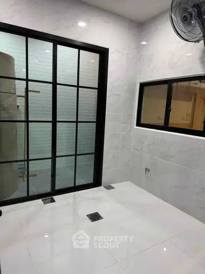 Modern bathroom with sleek tiles and large window for natural light