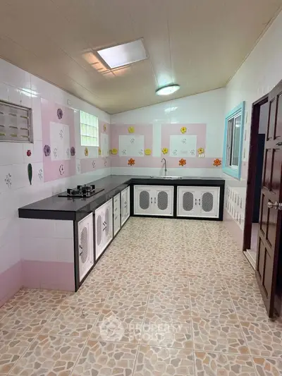 Charming kitchen with unique tile design and modern gas stove, perfect for culinary enthusiasts.