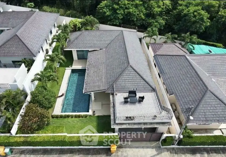 Luxurious villa with private pool and lush garden in serene neighborhood.