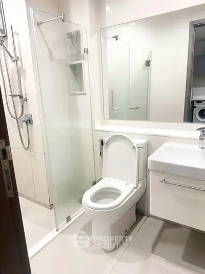Modern bathroom with glass shower and sleek fixtures in a contemporary apartment.