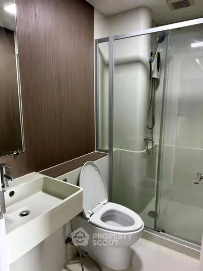 Modern bathroom with sleek shower and contemporary fixtures in a stylish apartment.