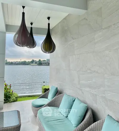 Luxurious waterfront balcony with stylish seating and stunning lake view