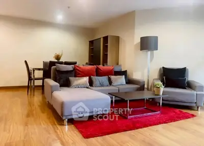 Spacious living room with modern furniture and vibrant red rug