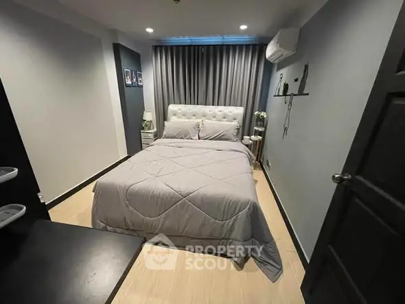 Cozy bedroom with modern decor and comfortable bed in stylish apartment.