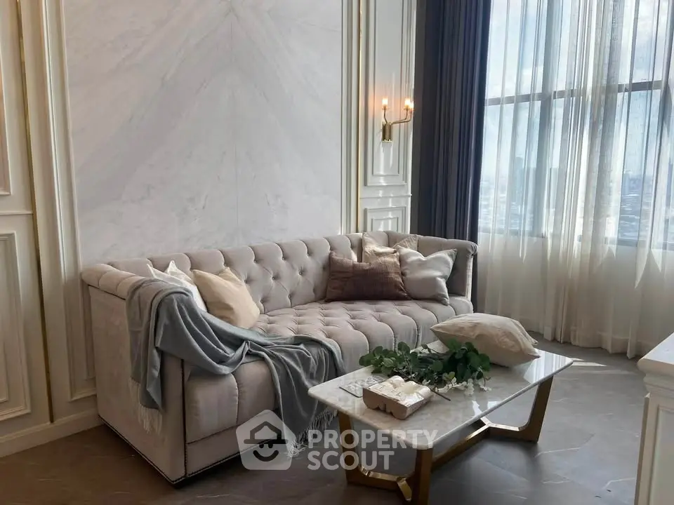 Luxurious living room with elegant sofa and marble coffee table, featuring floor-to-ceiling windows and chic decor.