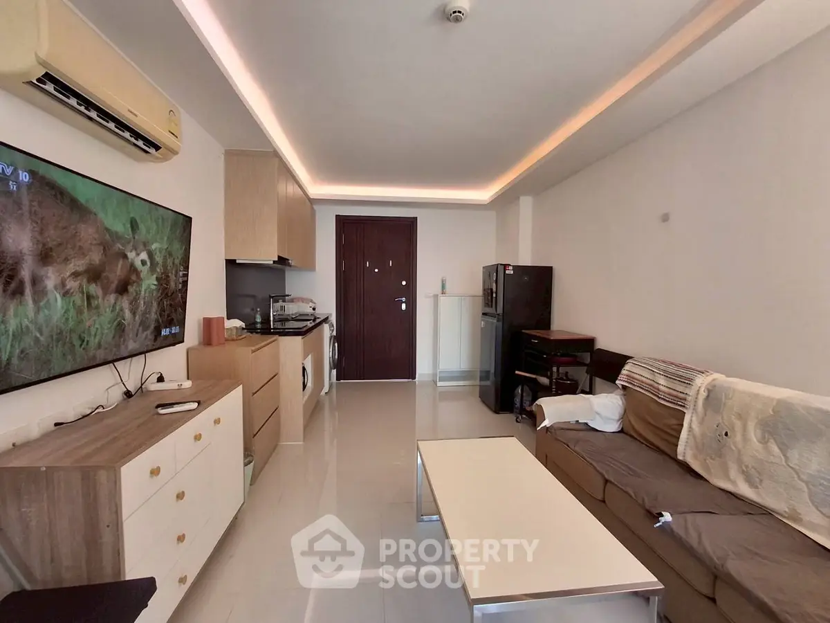 Modern living room with sleek design and integrated kitchen area