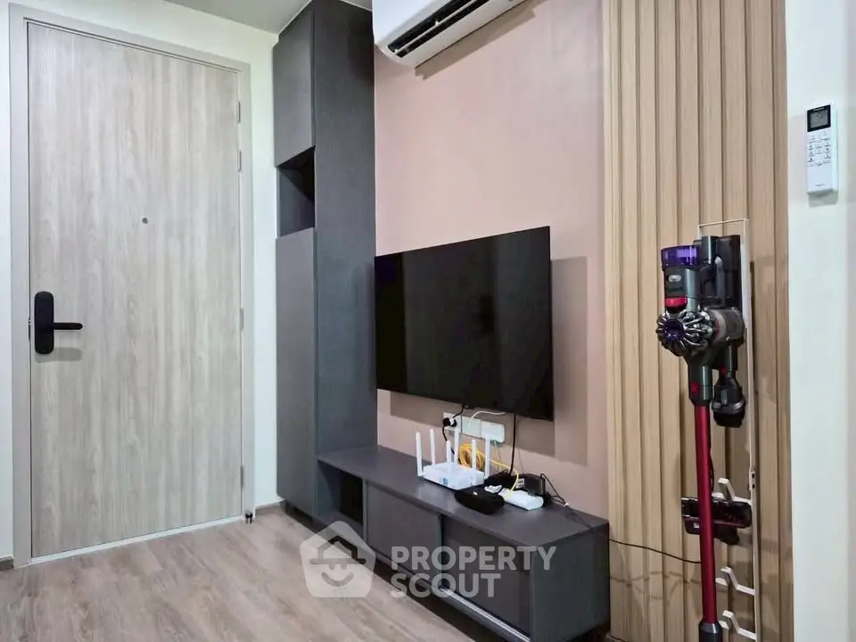 Modern living room with sleek TV setup and stylish storage solutions.