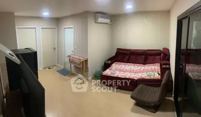 Cozy living room with modern furniture and air conditioning, perfect for relaxation.