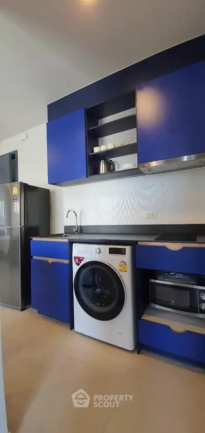 Modern kitchen with blue cabinets and built-in appliances