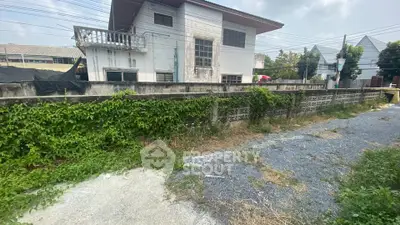 Charming fixer-upper house with potential, featuring a spacious yard and lush greenery, perfect for renovation enthusiasts.